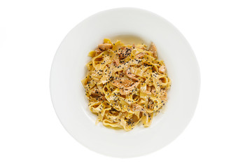 Pasta, noodles with fish and sesame, decorated with cheese. Isolated white view from above Serving a meal in a cafe, restaurant.