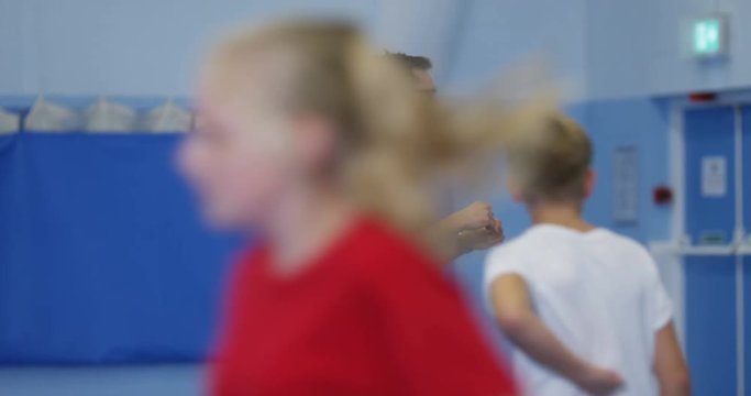 4k, Male coach having a pep talk with the school basketball team. Slow motion.