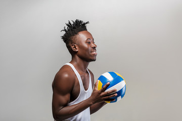 athletic African-American man with volleyball
