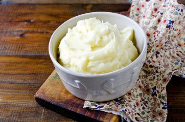 Mashed potatoes in a bowl on a wooden table