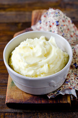Mashed potatoes in a bowl on a wooden table