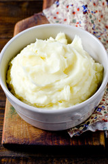 Mashed potatoes in a bowl on a wooden table