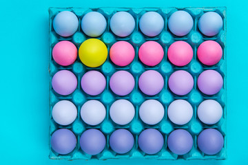 Vibrant shades of painted eggs in tray