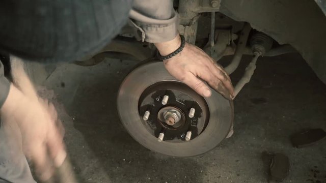 Closeup video of car disc brakes servicing