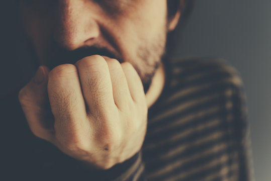 Nervous man bites fingernails