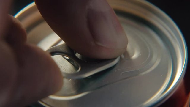 Fingers close-up, opening a cold can of Coca Cola. Cold drink Soda thirst quenching
