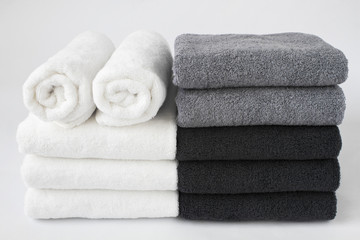 Stack of bath towels isolated on white background. - obrazy, fototapety, plakaty