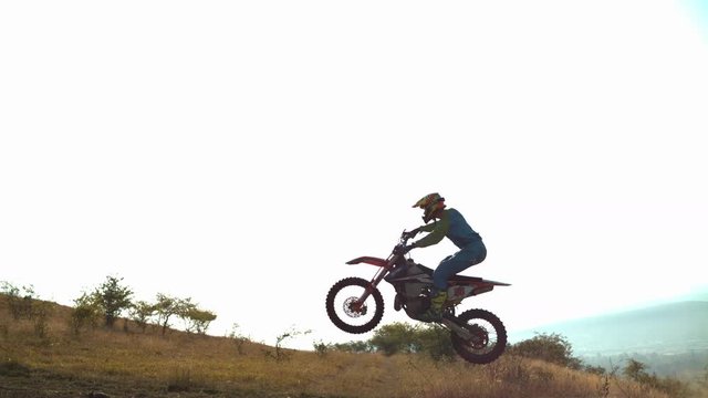 Motocross rider jumping with his motorcycle