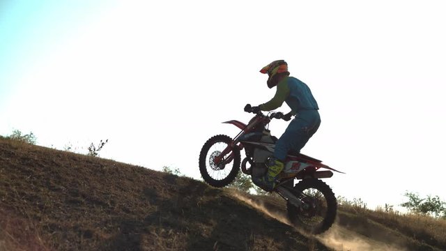 Motocross rider climbing a hill