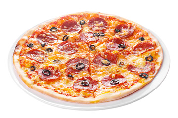 Pizza whole round, cut into pieces, on a white isolated background. Fast food in a pizzeria, a floury cheese product. Side view