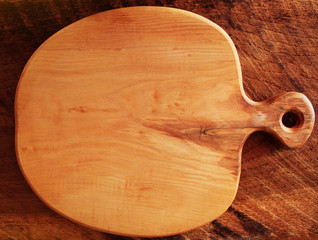 Empty vintage cutting board on wooden planks. Food background concept