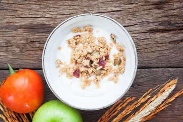 Yogurt with granola in a bowl on wooden table, Healthy and Clean food