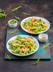 Two portions of green pasta