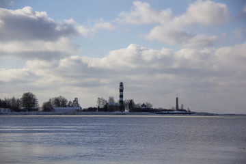 Logistics and transportation  Cargo ship with ports crane bridge coming in port and transportation industry winter suny day in Latvia baltic sea an river daugava.