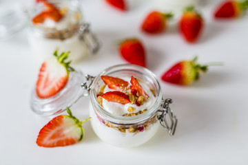 Delicious yogurt with e fresh strawberries and granola. 