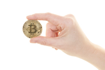 Female hand holding a bitcoin between the fingers on a white background