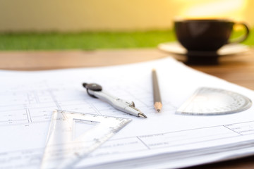 Desk work table architect with drawing home plan building and stationary in home office includes copyspace for add text or graphic