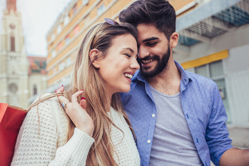 Fototapeta premium Happy couple shopping together and having fun in city.