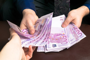 Human hands exchanging money - closeup shot