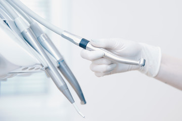 Stomatological instrument in dentists clinic. Doctor dentist takes dentistry instrument