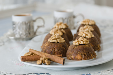 Traditional Turkish sweet dessert halva with walnut on the white plate.