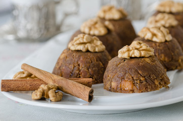 Traditional Turkish sweet dessert halva with walnut on the white plate