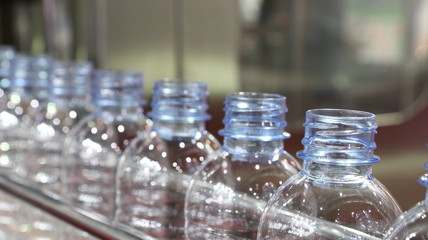 PET water bottles in conveyor ; industry background ; environment issue