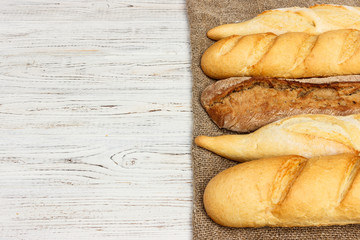 Assortment of fresh French baguettes on a wooden table