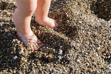children's feet in the sand