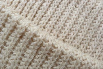 knitted scarf close-up beige knitted fabric yarn wool acrylic cotton natural thread close-knit vintage background for decoration hand-made background made by hand