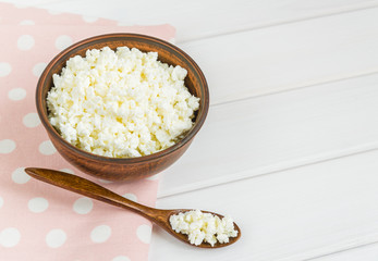 Cottage cheese with apples for breakfast in a bowl close up. pink polka dot napkin. Top view image. Copyspace for your text