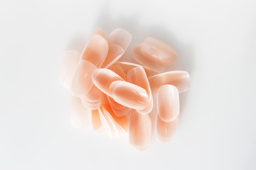 many plastic pink tips for nail extension and training in applying design while training a manicure.