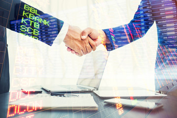 Double exposure business concept, businessman handshake in office workspace for investment