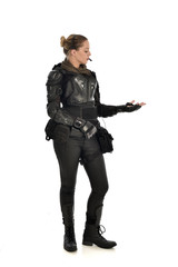 Fototapeta premium full length portrait of female soldier wearing black tactical armour with arms raised, isolated on white studio background.