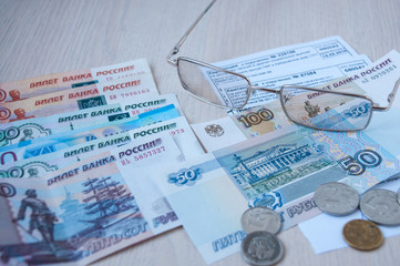 Russian money, glasses and receipts for pension are on the table