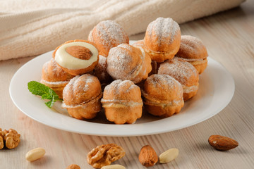 Sweet and delicious russian walnut cookies (filled with condensed milk and almonds) on the white plate.