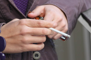 Cigarettes. Young women smoke cigarettes. Smoking cigarette . Young people smoke cigarettes