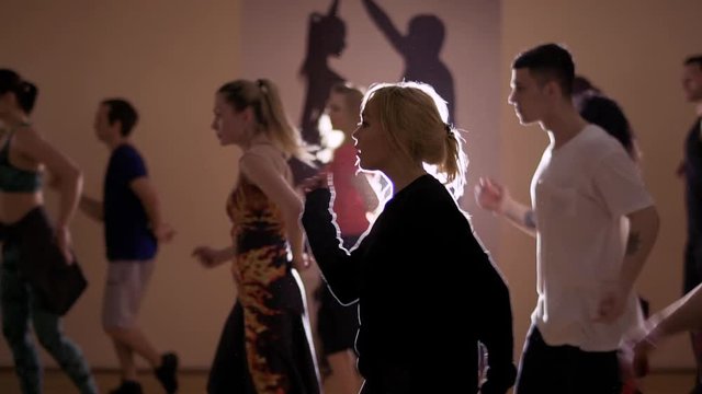 People are dancing to the beat of music in the studio