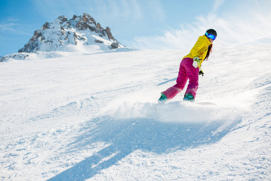 Picture of sports woman snowboarding on snowy slope