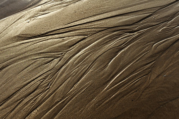 At low tide the retreating water forms nice shapes on the sandy beach
