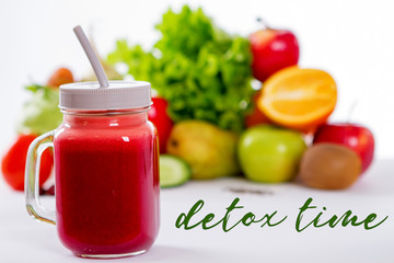 Vegetable smoothie in small bottles, dark wood background, selective focus