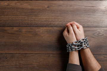 Close-up, men's hands are chain-bound. The concept of arrest, imprisonment, cumbersome, justice.
