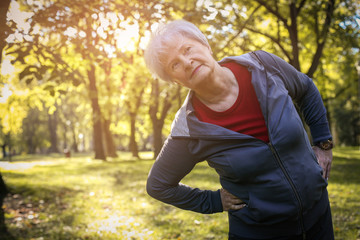 Active senior woman working exercise and stretching back.