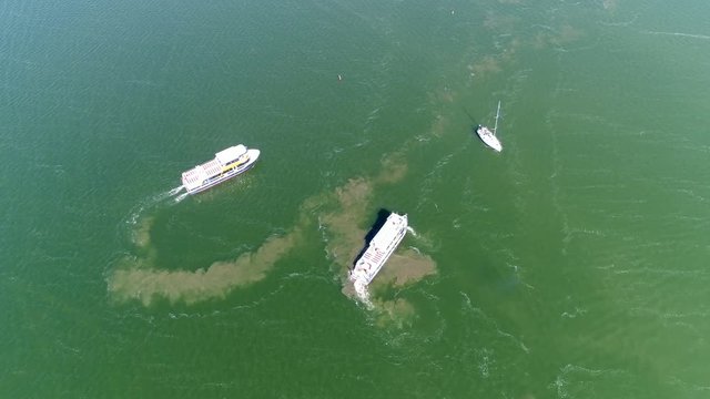 Aerial top down view of two ship forming formation in shallow water showing the sand mixed up from bottom of shallow lake beautiful view of water landscape steady drone view 4k high resolution
