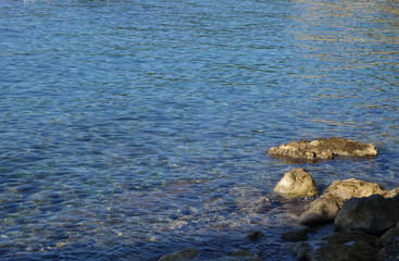 Sea pebble and stones near coast..Sea pebble and stones near coast. Water and stones.