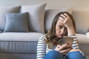 Portrait of young sad annoyed woman, receiving bad sms