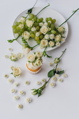 spring cupcake on a white background with flowers and fruits aro