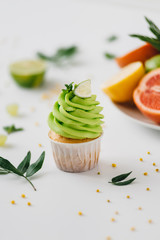 spring cupcake on a white background with flowers and fruits around.