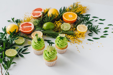 spring cupcake on a white background with flowers and fruits aro