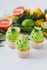spring cupcake on a white background with flowers and fruits aro